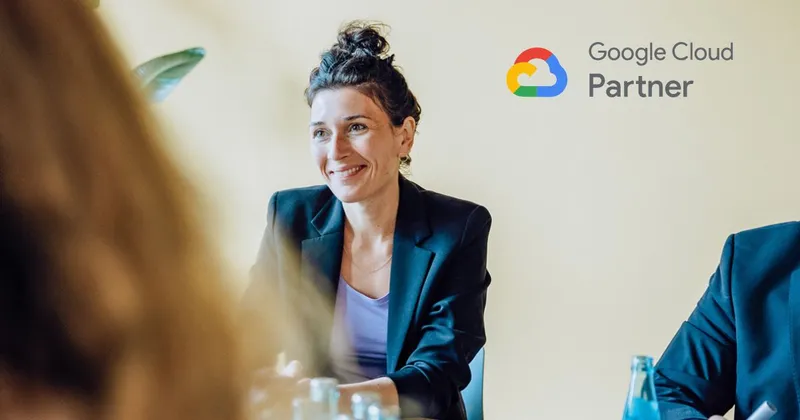 A woman in a dark blazer and light top, smiling and looking to the left. The Google Cloud Partner logo is in the top right corner.